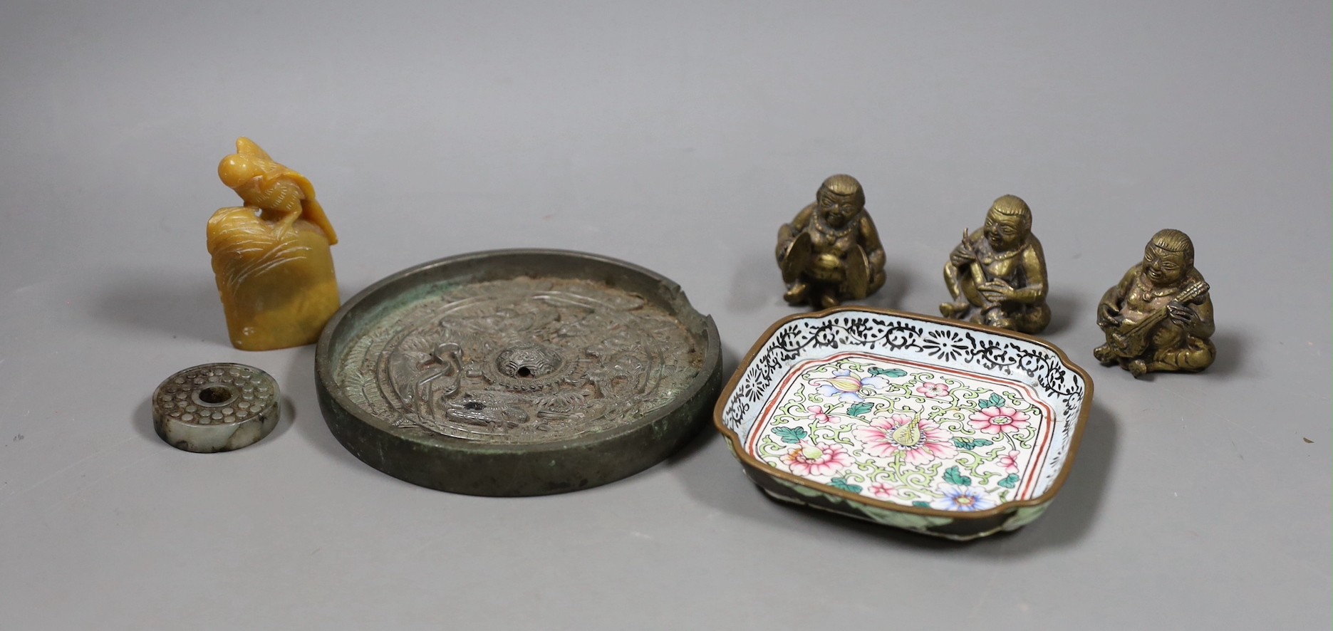 A group of assorted Chinese items to include jade bi disc, a Canton enamel dish, a bronze mirror, a soapstone seal, etc.